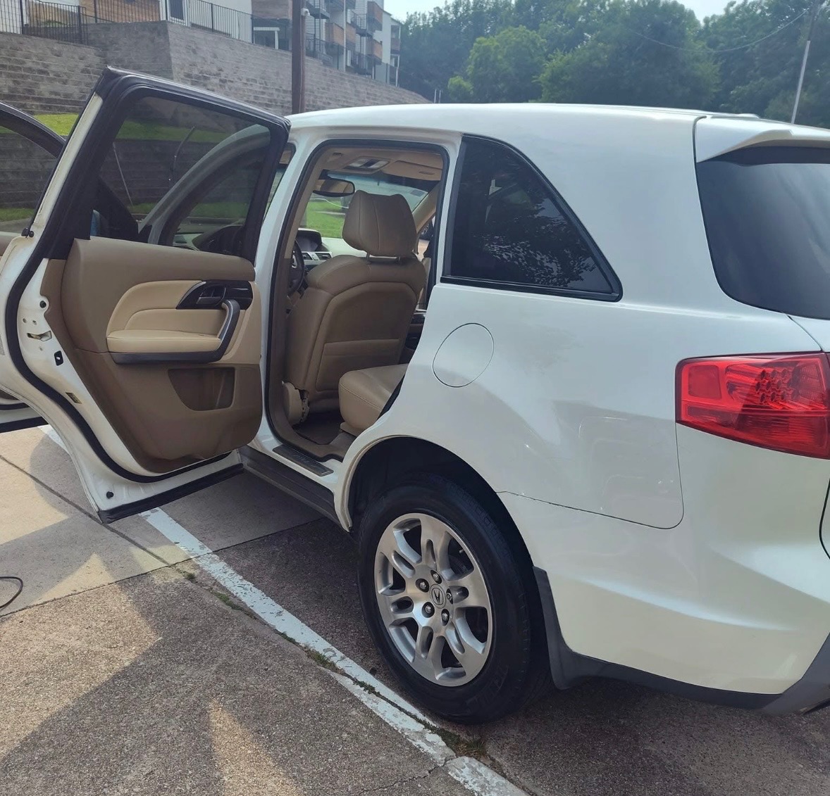 White Acura SUV with rear door open after detailing